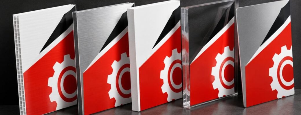 Coroplast, ACM, PVC, acrylic and aluminum sign samples leaning in a row