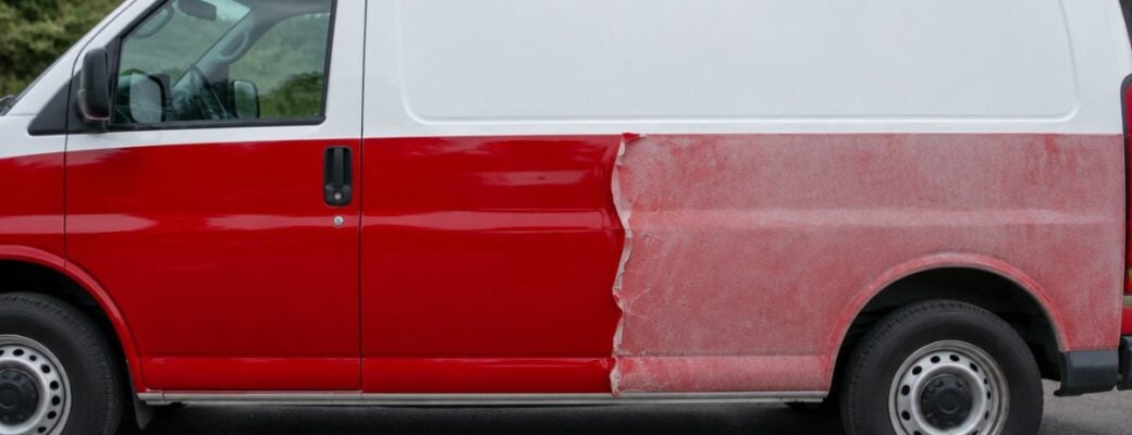 Wrapped van with the red wrap fresh on one half and faded and lifting on the other
