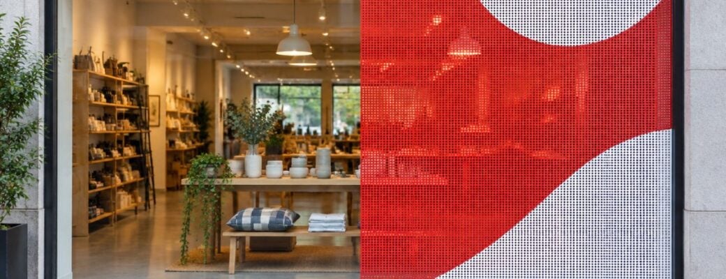 Storefront window, plain glass on the left and perforated window film on the right