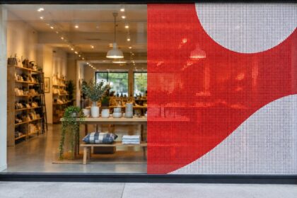 Storefront window, plain glass on the left and perforated window film on the right